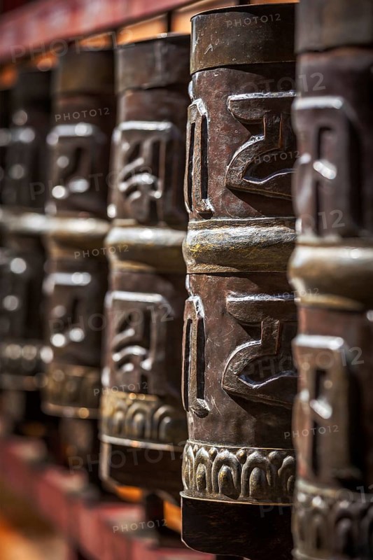 Tibetan Buddhist prayer wheels in Buddhism temple. Shallow depth of field. Rewalsar