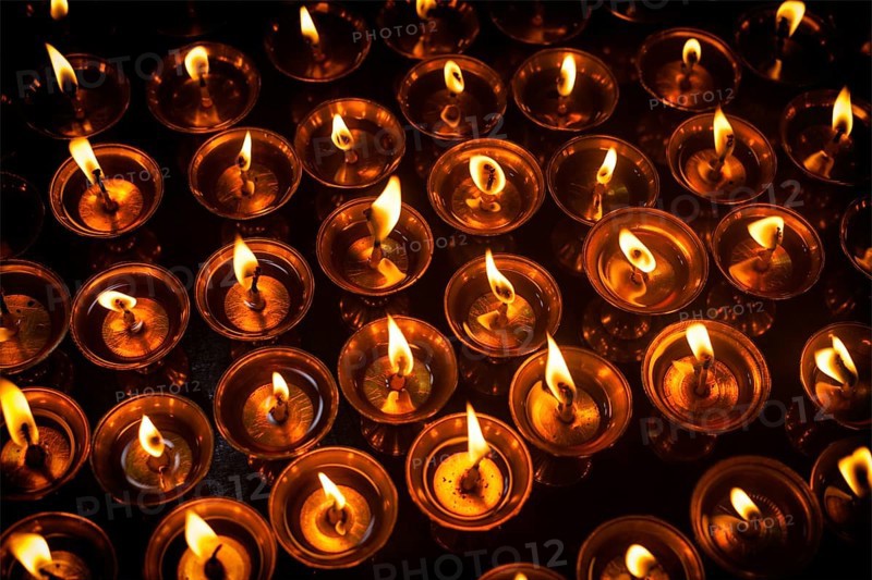 Burning candles in Tibetan Buddhist temple. Himachal Pradesh