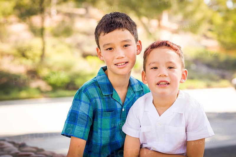 Outdoor portrait of biracial chinese and caucasian brothers