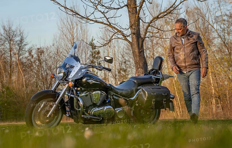 Man in leather jacket circles his motorbike
