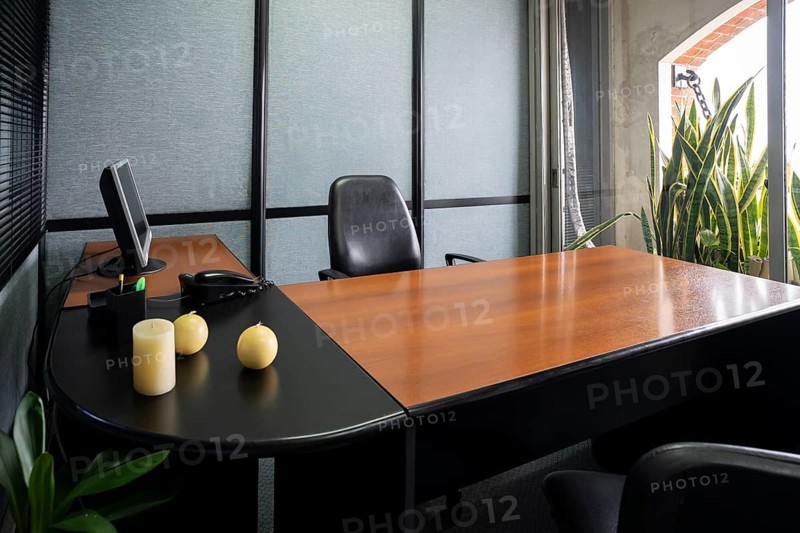 Empty office in a classic style with a large desk and a large window
