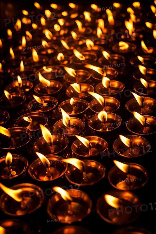 Burning candles in Tibetan Buddhist temple. Himachal Pradesh