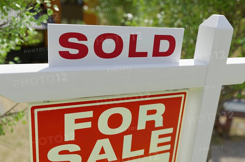 Sold for sale real estate sign in front of property