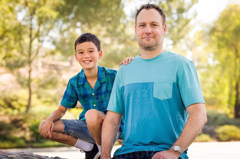 Outdoor portrait of biracial chinese and caucasian father and son