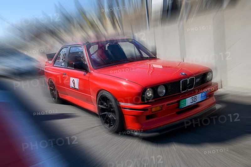 Dynamic photo with zoom effect of sports car racing car red BMW M3 S54 leaving pit lane
