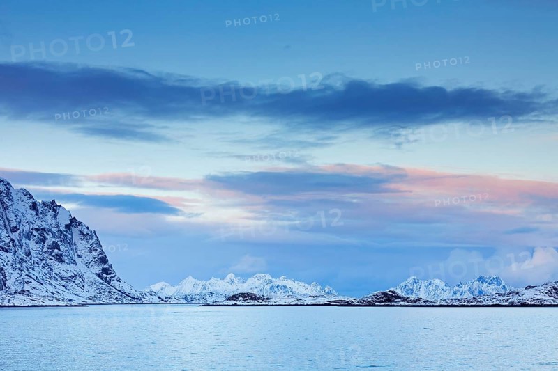 Mountains in the snow in winter by the fjord of Henningsvaer