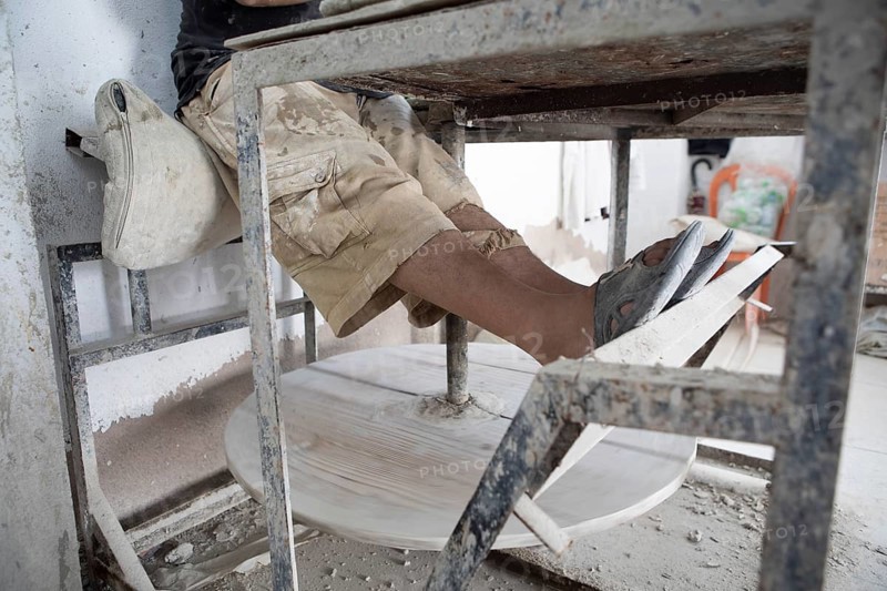 Legs at a pottery table