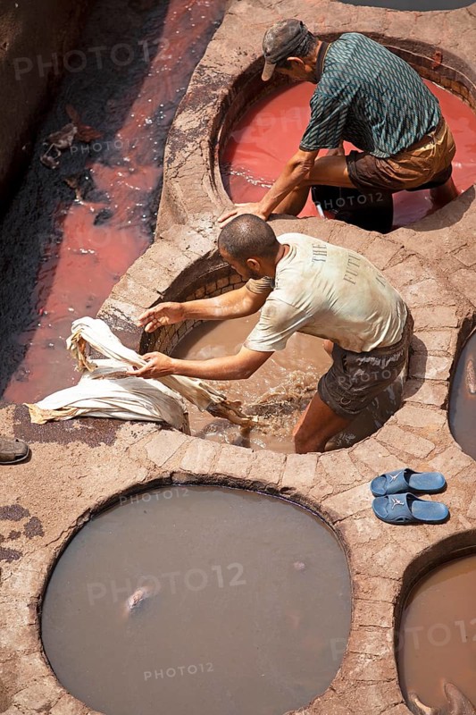Workers dyeing leather