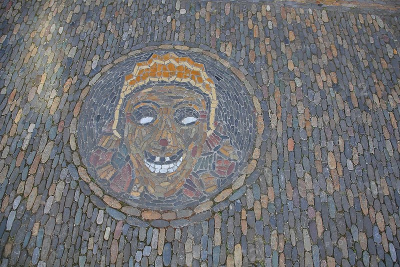 Round floor mosaic for Halloween with head and face made of colourful stones in Freiburg