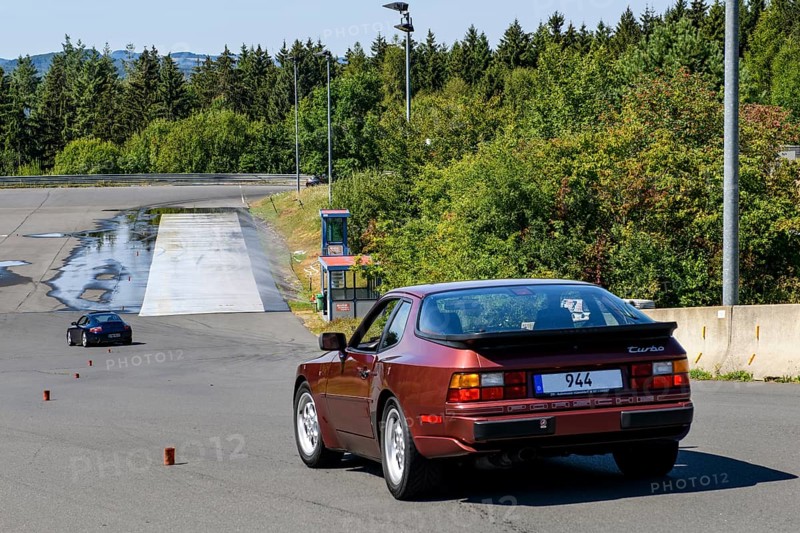 Historic sports car Porsche 944 Turbo Oldtimer Classic Car starts to keep control at slalom course at driving safety training