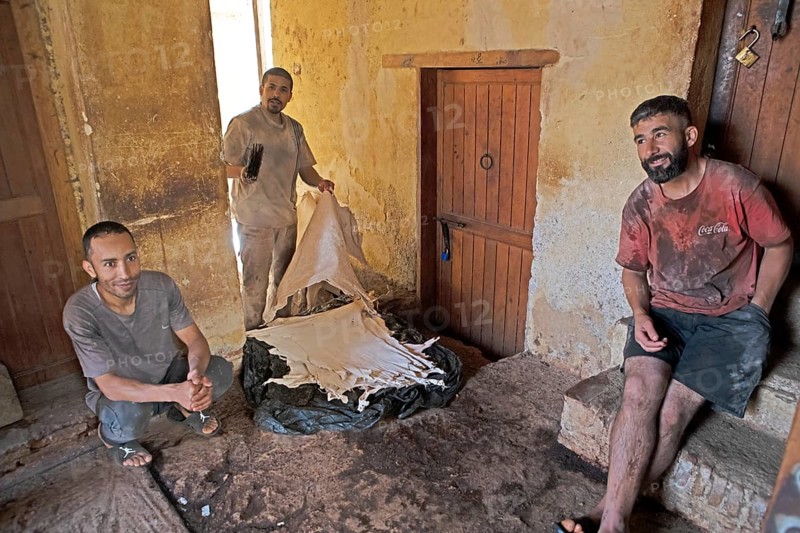 Workers sorting leather