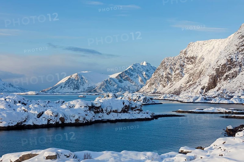 Mountains in the snow in winter by the fjord of Henningsvaer