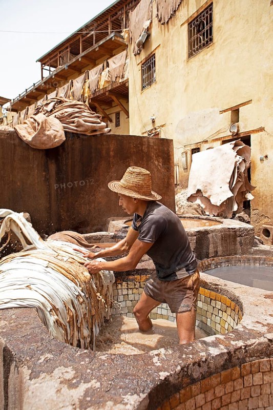 Workers dyeing leather