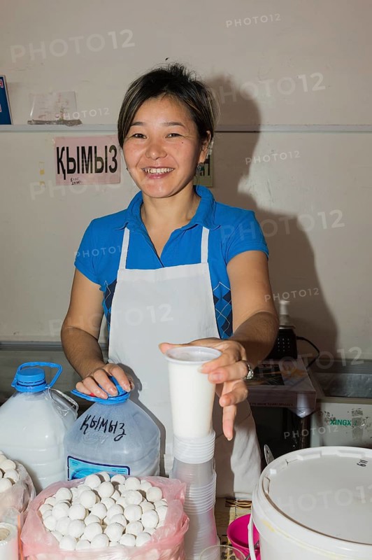 Kazakh woman selling kumis made from mare's milk