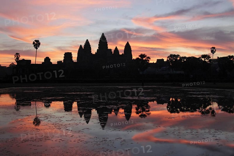 Khmer temple silhouetted at sunrise