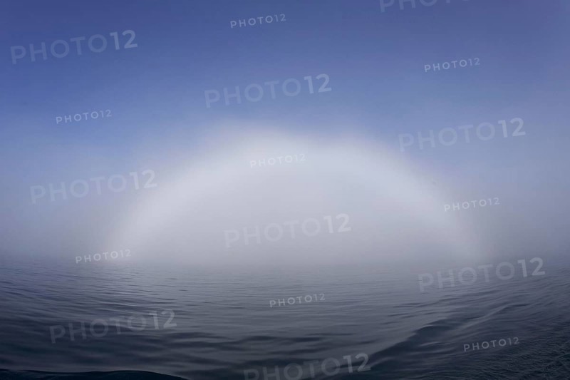 Bow of fog over calm sea