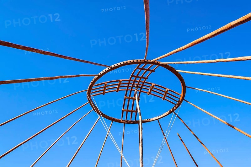 Kazakh men erecting the roof of a yurt