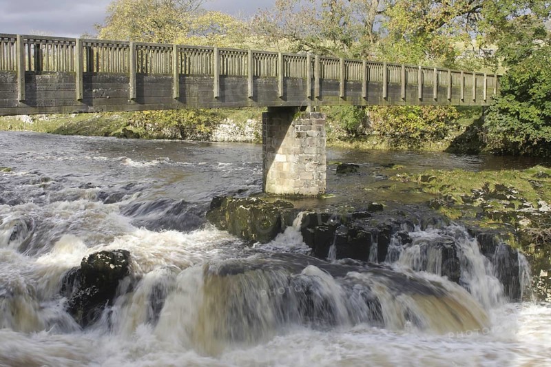 Bridge and cascades over limestone cliffs