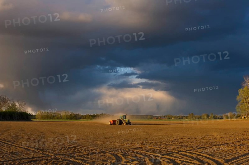 Tractor drilling farmland