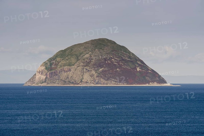 View of volcanic plug island and sea