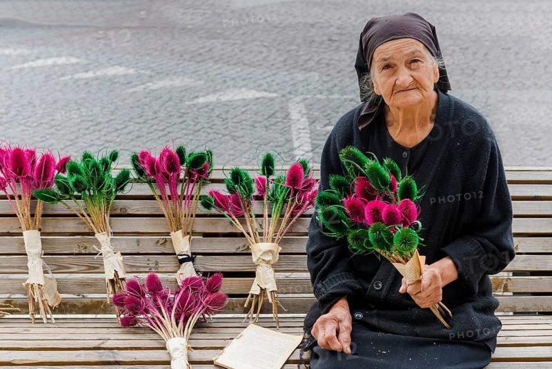 Georgian woman selling flowers on a bench