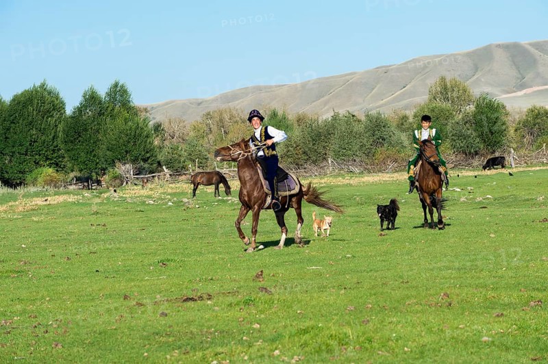 Two Kazakh horsemen in traditional dress