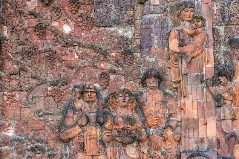 Close-up of communist-era faces on the facade of the city market
