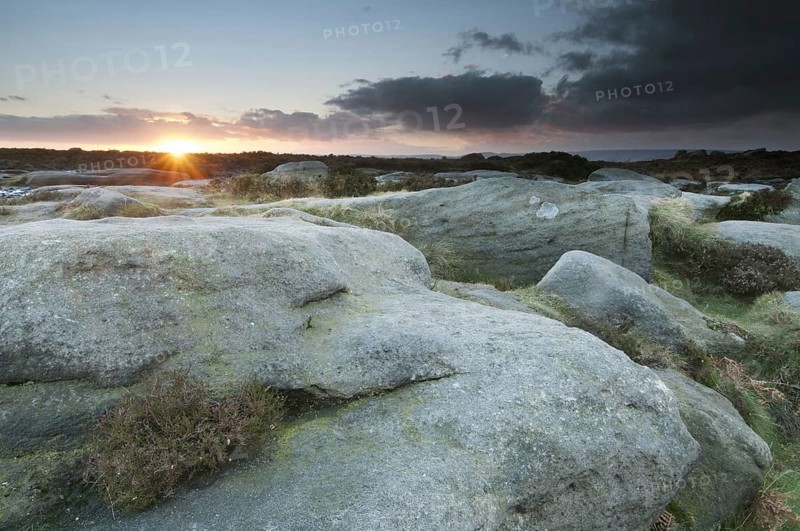 View from Gritstone rocks onto moorland habitat at sunset