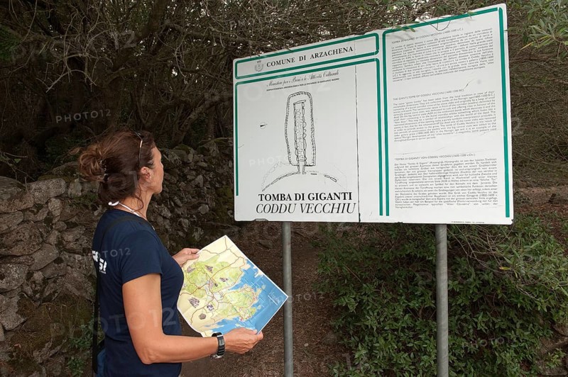 Holidaymaker looking at information board at the Tomb of the Giants