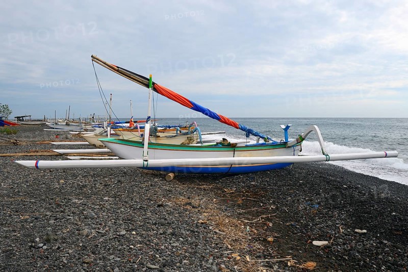 Traditional colourful outrigger boats on the black lava beach of Lovina