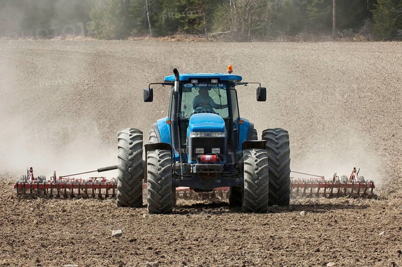 New Holland 8770 tractor with harrows