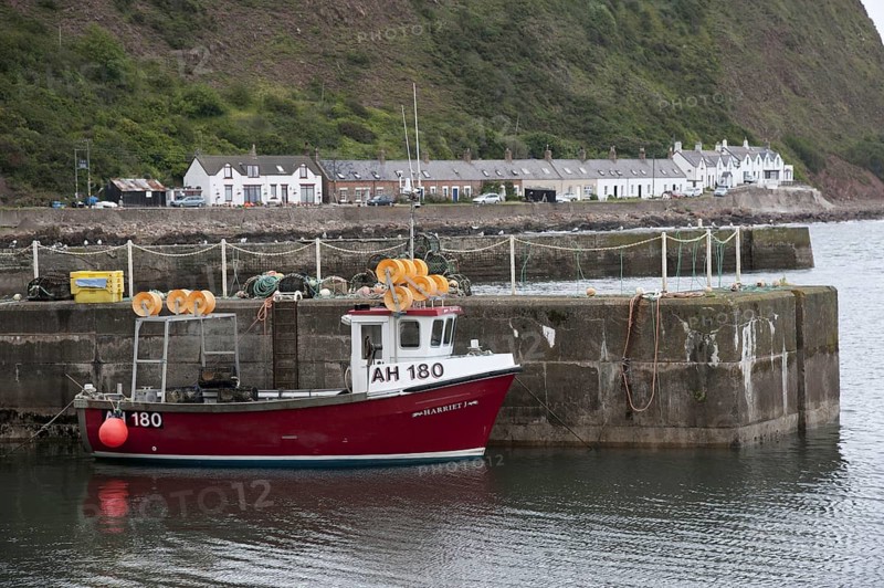 Lobster fishing boat at harbour of fishing village Burnmouth