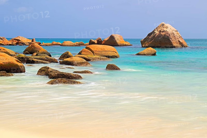 Granite rocks and beach of Anse Lazio in the evening
