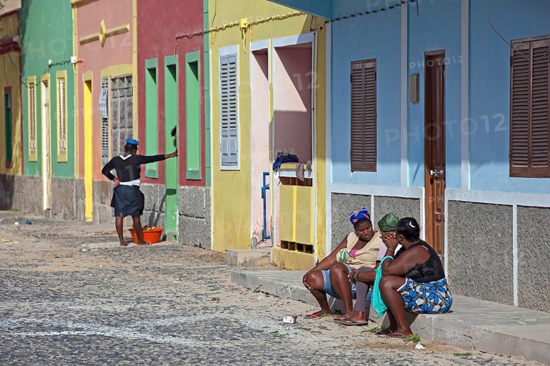 Creole woman talking on the doorstep in the street in the village of Sal Rei on Boa Vista Island