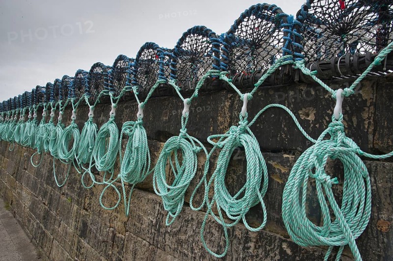 Lobster pots on quayside of harbour