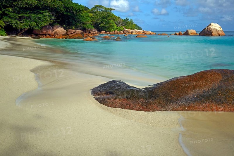 Beach and rocks of Anse Lazio in the evening