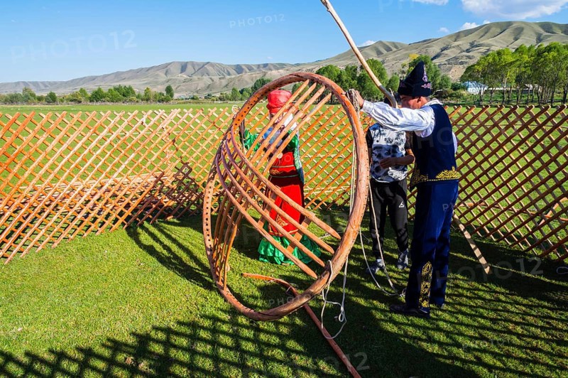 Kazakh men building a yurt