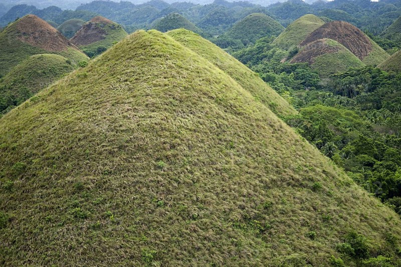 Cone-shaped karst hills of grass-covered limestone