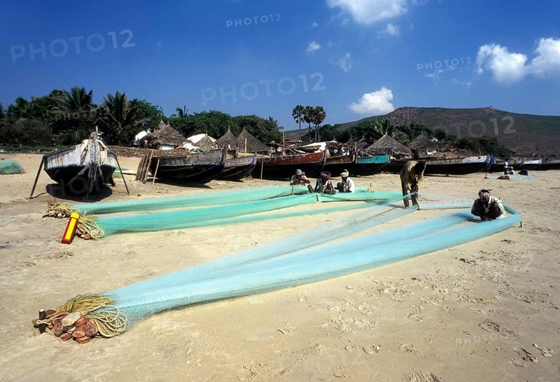 Fishermen repairing their fishing nets in Gangavaram