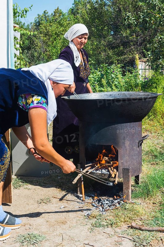 Kazakh woman preparing traditional local tandyr bread