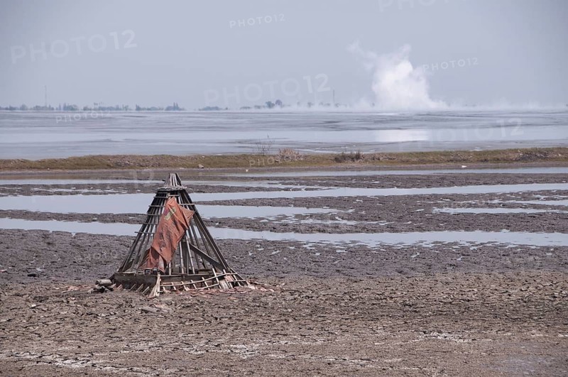 Mosque buried in mud lake of mud volcano