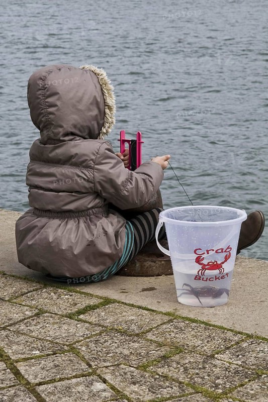 Young girl crabbing on cold day