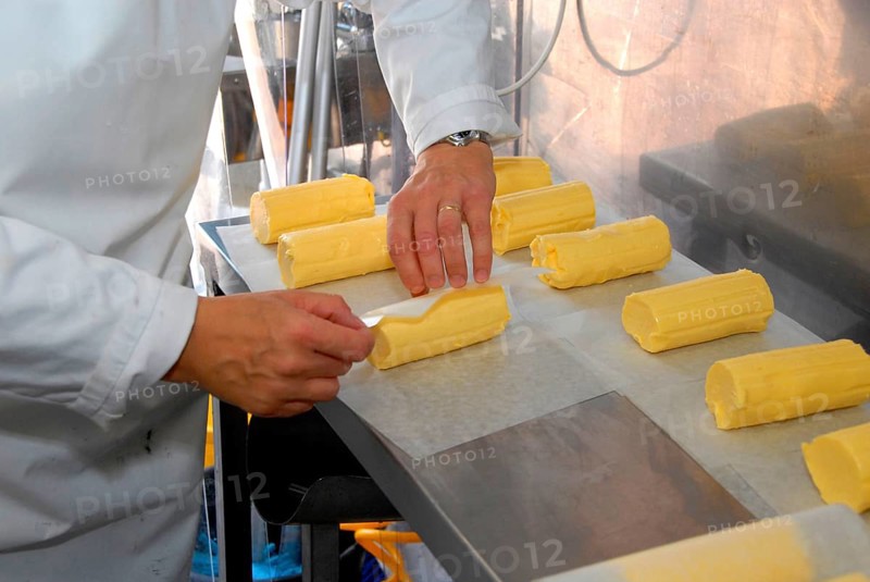 Worker wrapping organic butter made from unpasteurised milk