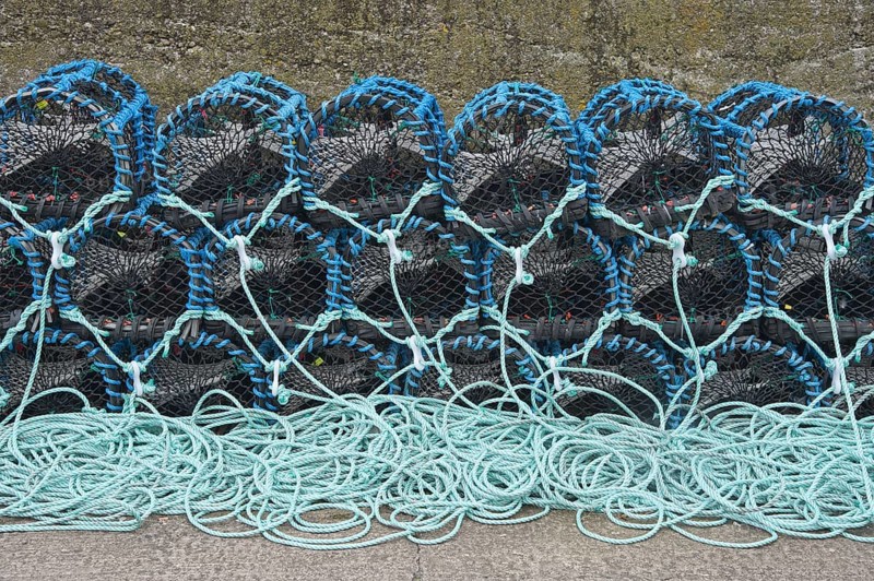 Lobster pots on quayside of harbour