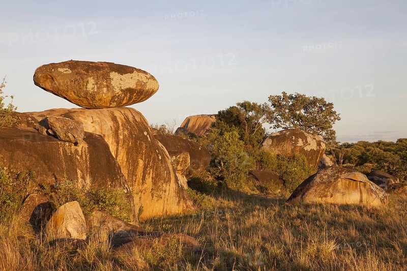 View of savannah with kopje rock formations in dawn sunlight