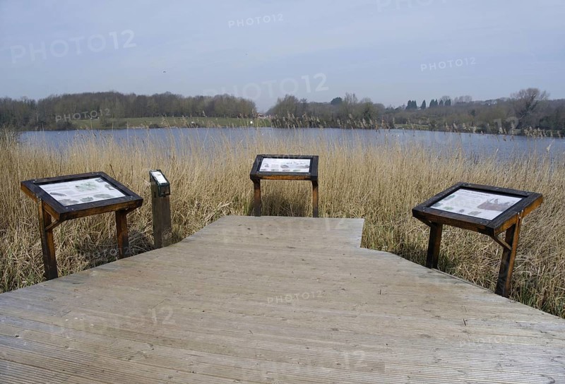 Boardwalk and information boards overlooking the lake in a flooded former limestone quarry