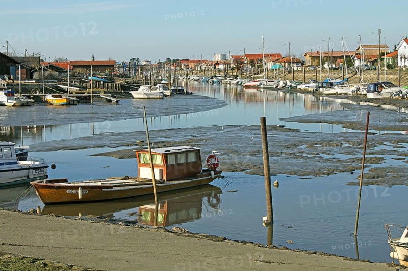 View of coastal creek with boats at low tide