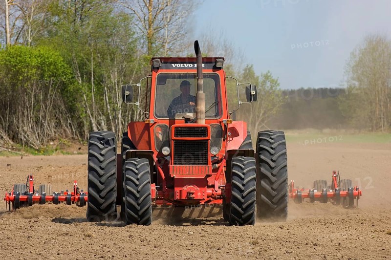 Volvo tractor pulling harrows