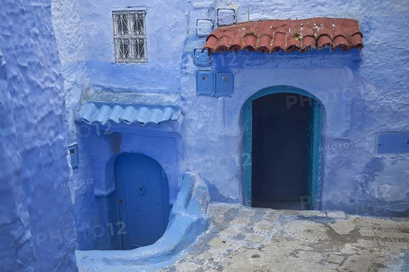 Blue doors and houses in alley of city