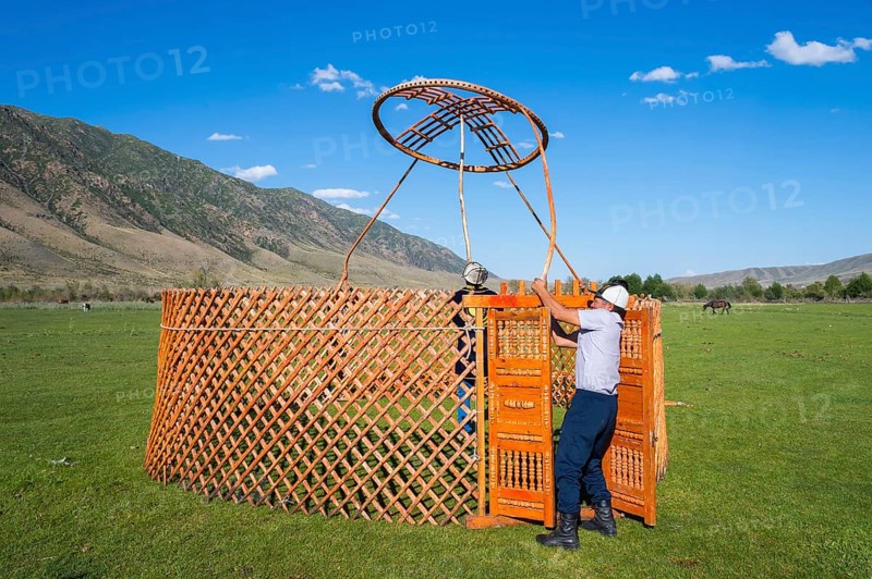 Kazakh men building a yurt